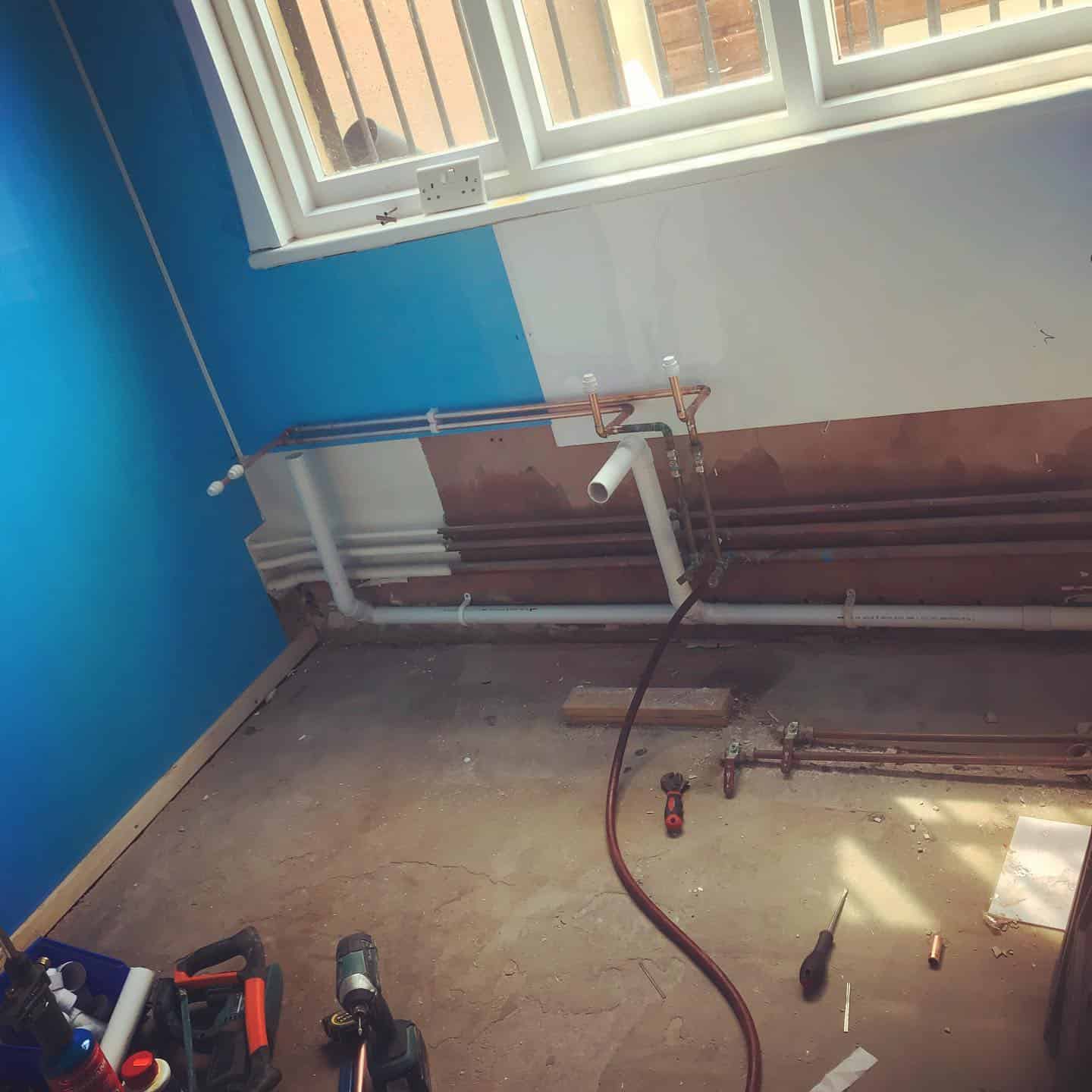Installation of plumbing pipes and fixtures for residential or commercial buildings by expert plumbers.