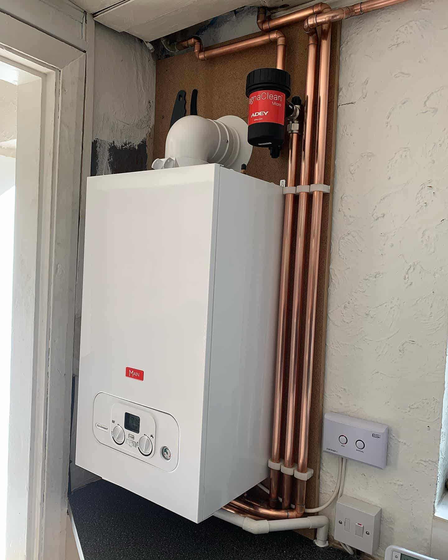 Efficient boiler installation with copper pipes for home heating.