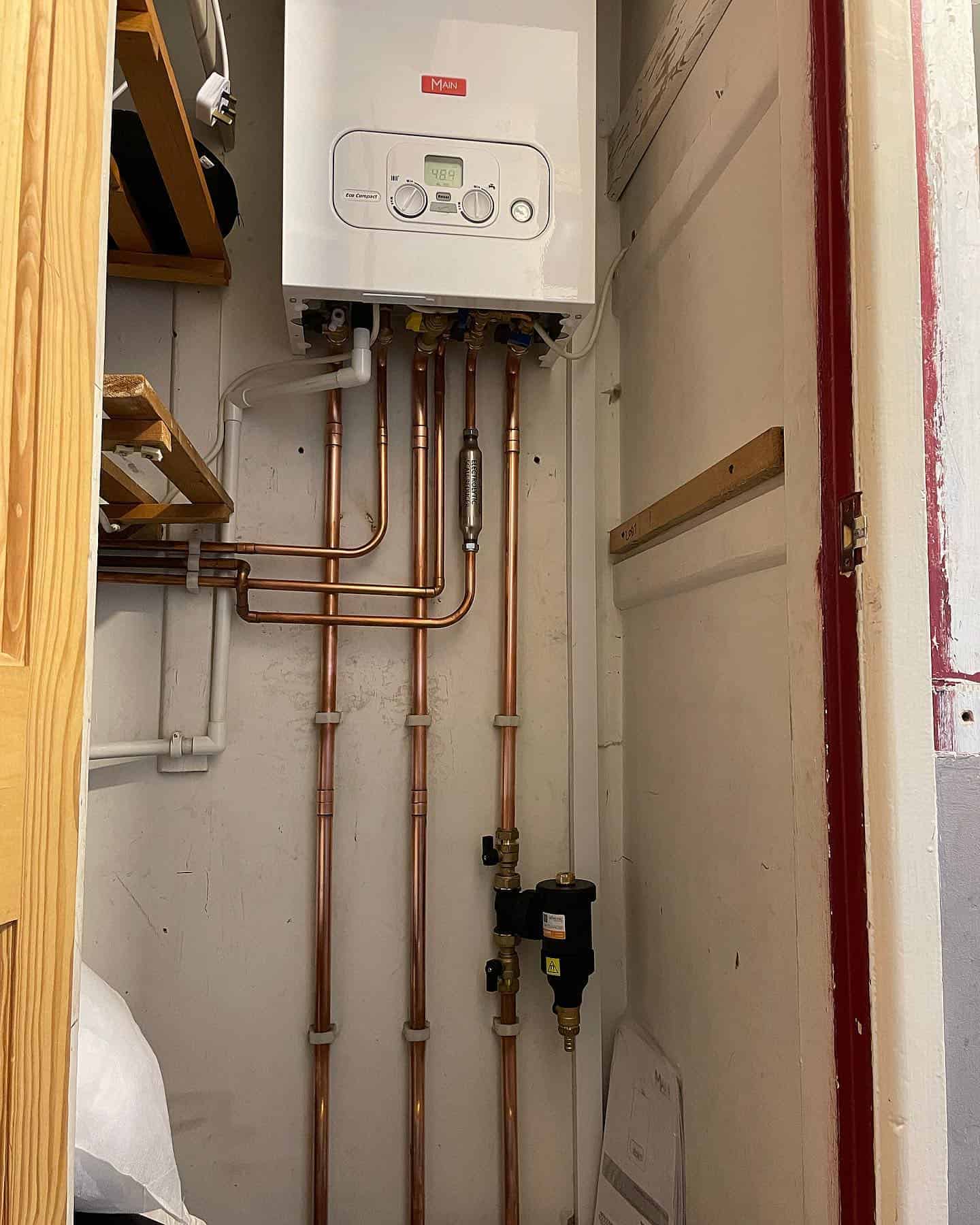 High-efficiency boiler with copper pipes for reliable heating solutions. Trusted plumbing and heating contractor.