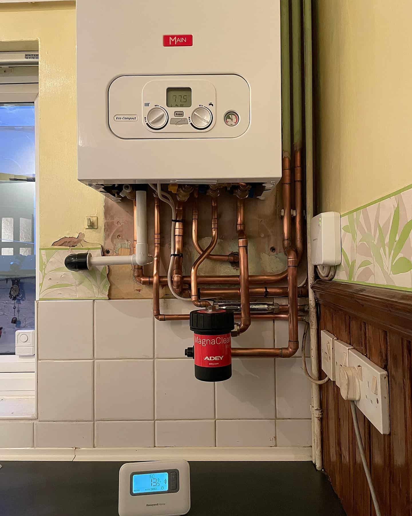 Boiler with copper pipes, heating system, plumbing, and heating services.